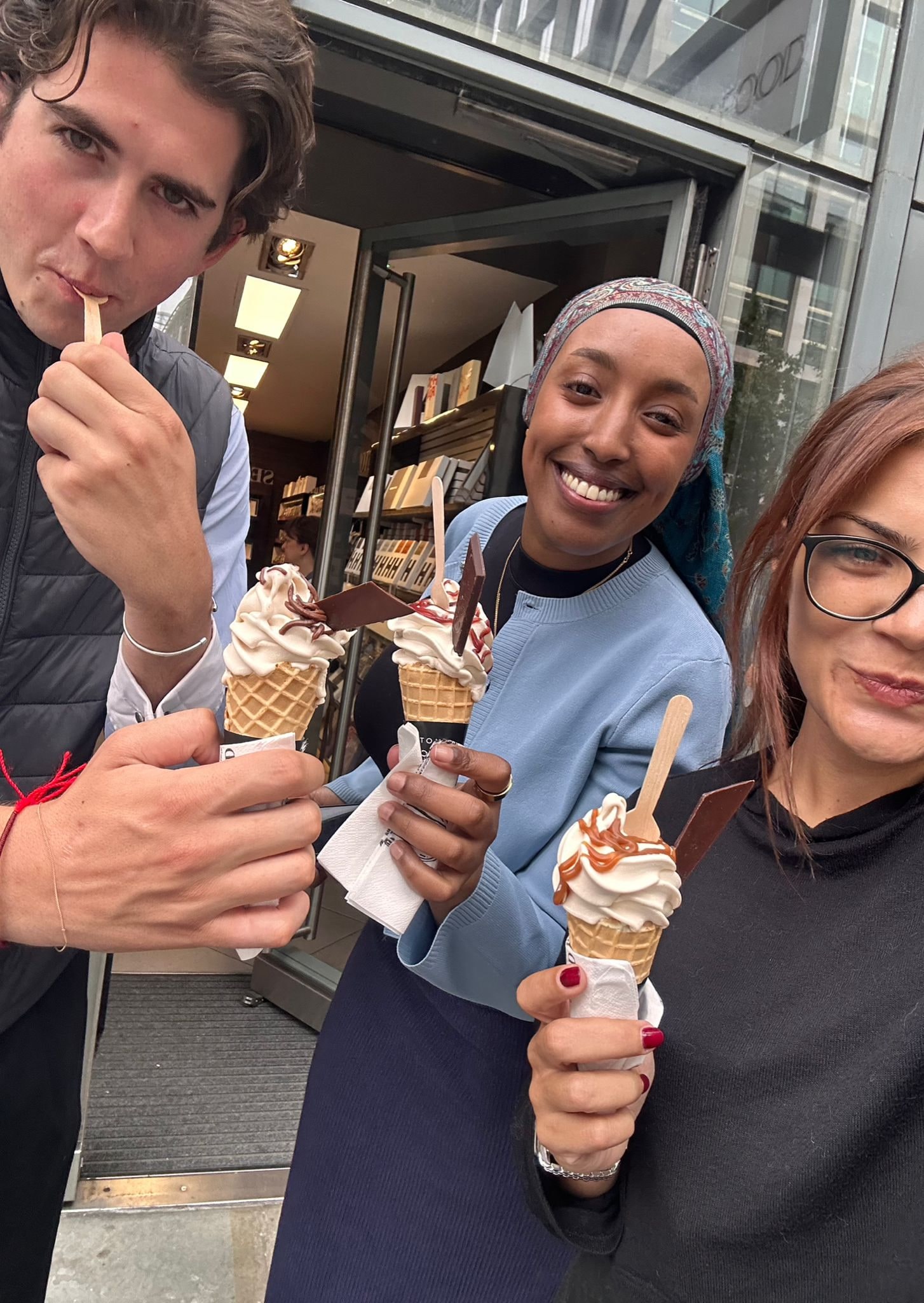 Louis and two colleagues holding ice creams outside the office