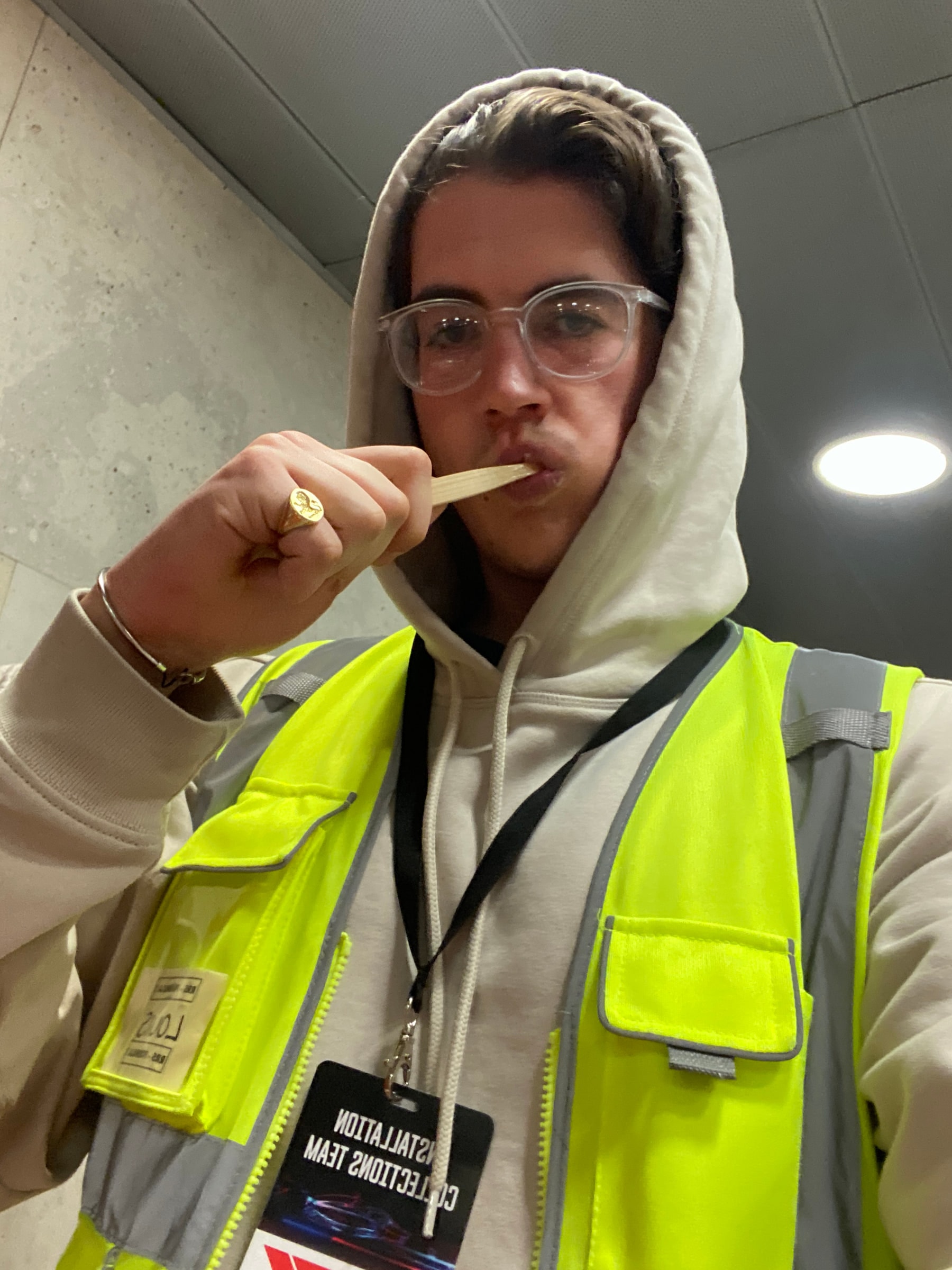 Louis in a hi-vis vest and lanyard reading Installation Collections Team