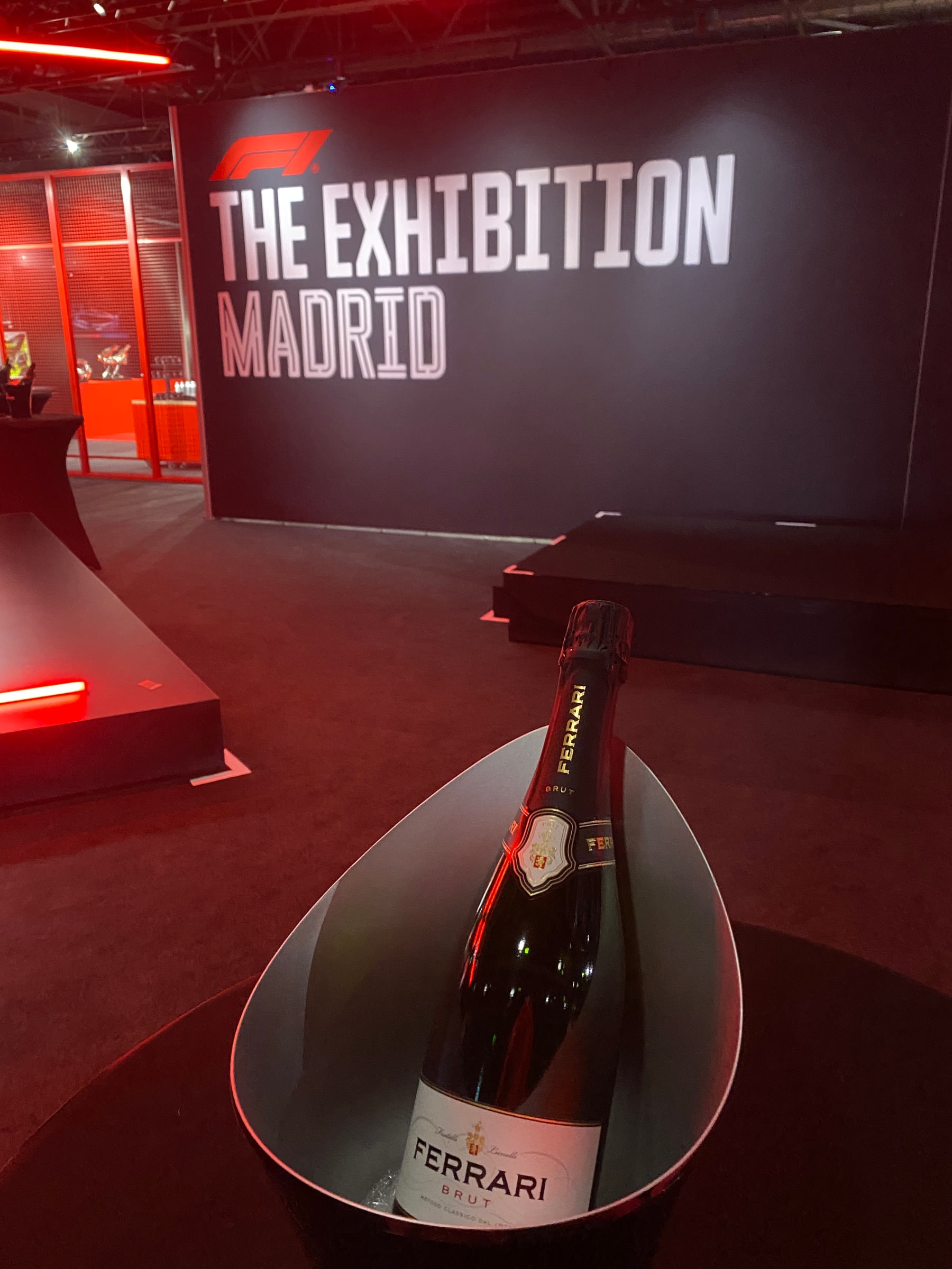 A bottle of Ferrari brut in an ice bucket in front of the exhibition sign